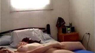 Horny brunette babe masturbates on her bed - porn video